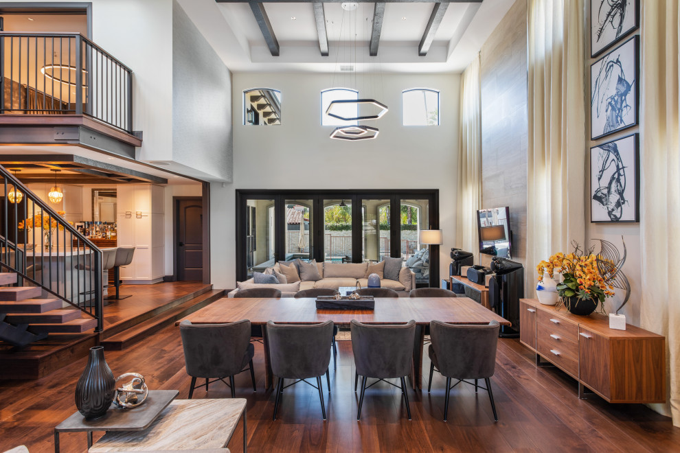 Design ideas for a large contemporary mezzanine living room in Los Angeles with dark hardwood flooring, brown floors and a wallpapered ceiling.