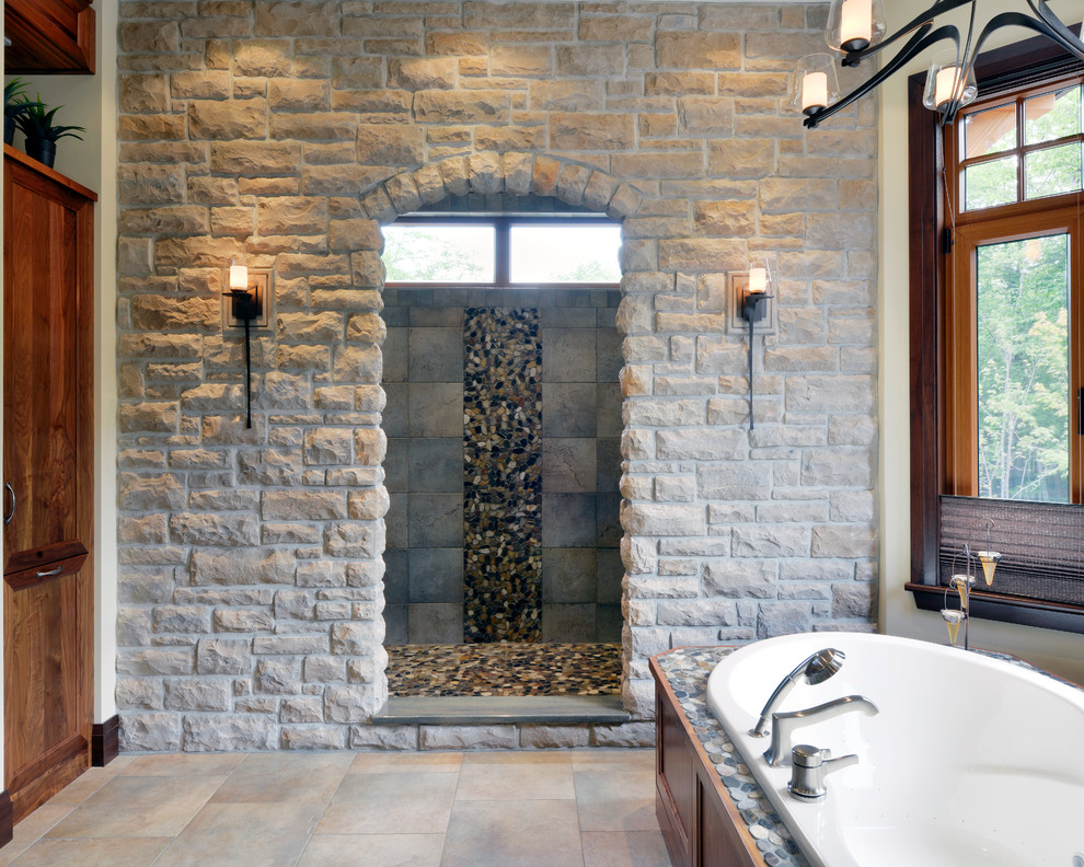 Design ideas for a traditional bathroom in Toronto with a freestanding tub and stone tile.