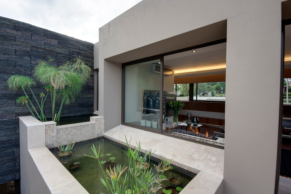 Design ideas for a contemporary garden in Other with a water feature.