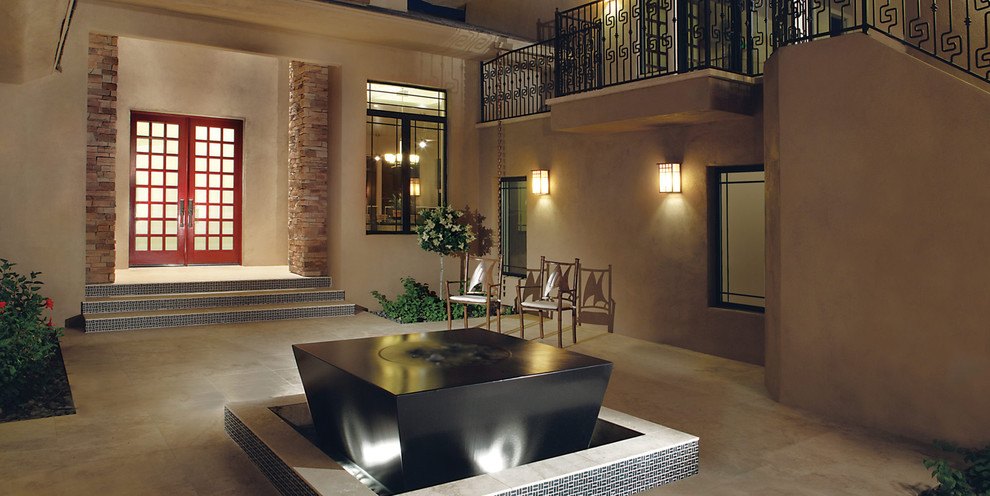 Inspiration for a mid-sized asian courtyard patio in Phoenix with a water feature, tile and no cover.