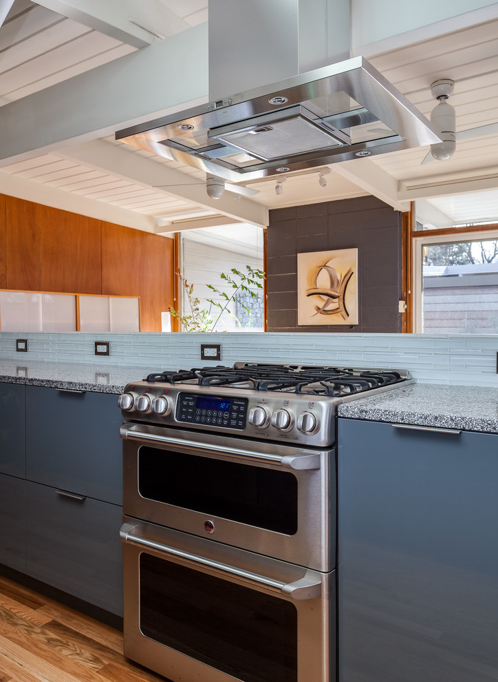 Small contemporary galley separate kitchen in Denver with an integrated sink, louvered cabinets, green cabinets, quartz benchtops, mosaic tile splashback, stainless steel appliances and dark hardwood floors.