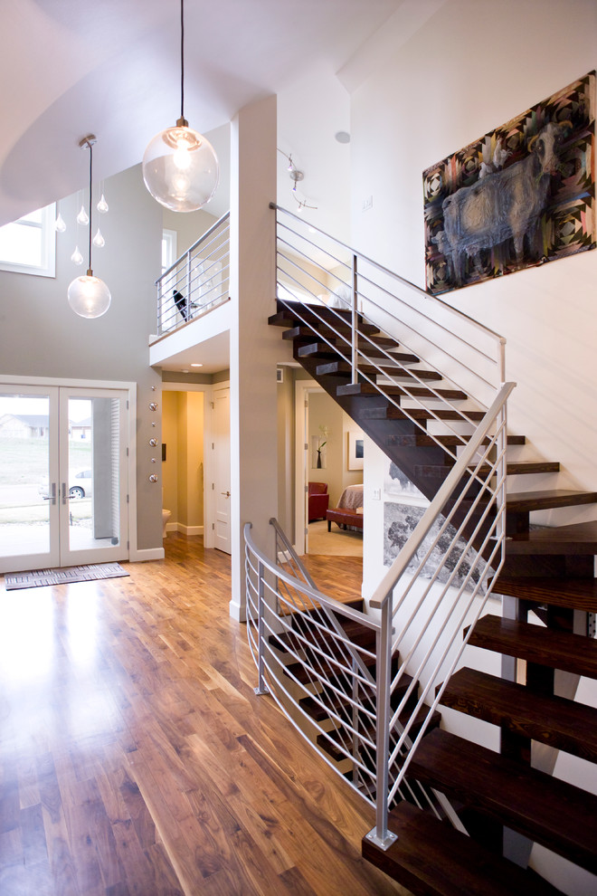 Contemporary wood staircase in Other with open risers.