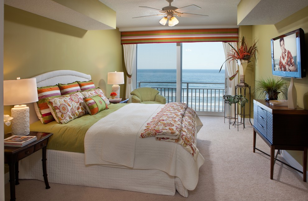 Design ideas for a mid-sized tropical guest bedroom in Tampa with green walls, brick floors, no fireplace and beige floor.