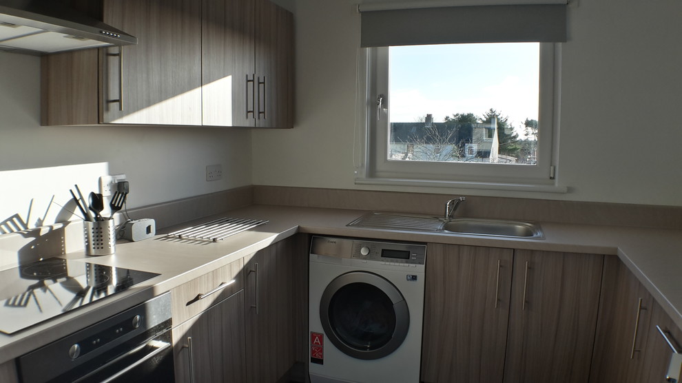 Photo of a medium sized modern u-shaped enclosed kitchen with white appliances, lino flooring and no island.