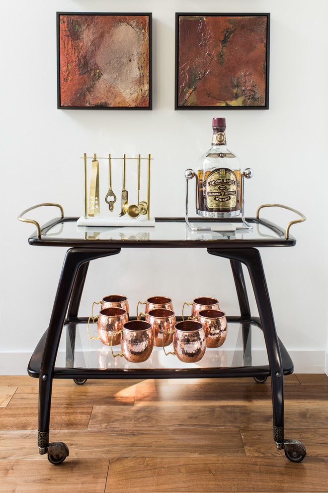This is an example of a mid-sized transitional bar cart in San Francisco with dark wood cabinets, medium hardwood floors and brown floor.