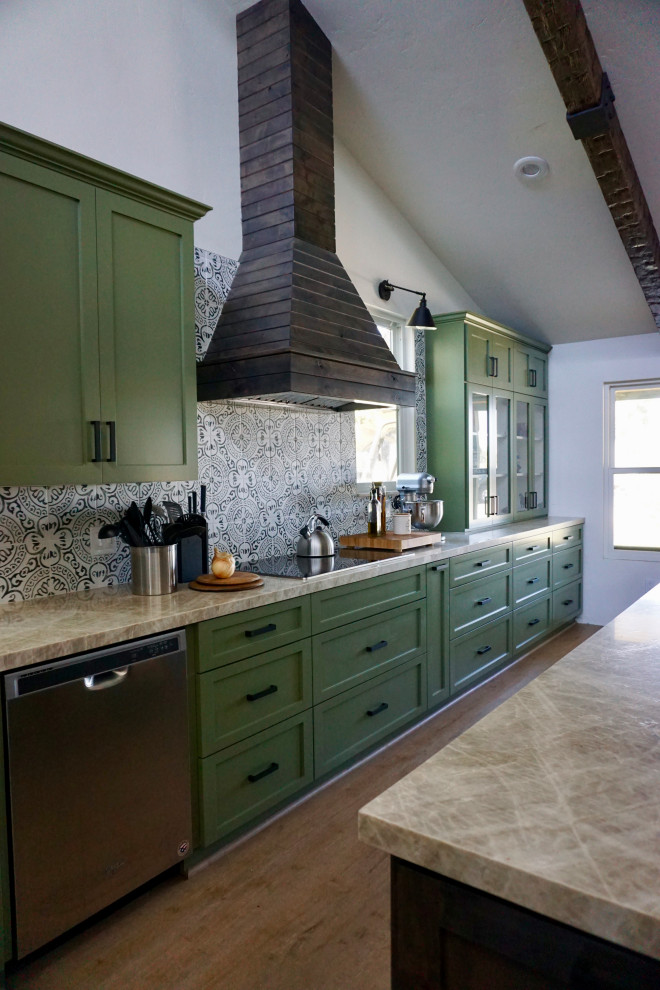 Photo of a mid-sized country eat-in kitchen in Other with a farmhouse sink, shaker cabinets, green cabinets, quartzite benchtops, multi-coloured splashback, ceramic splashback, stainless steel appliances, ceramic floors, with island, beige floor and beige benchtop.