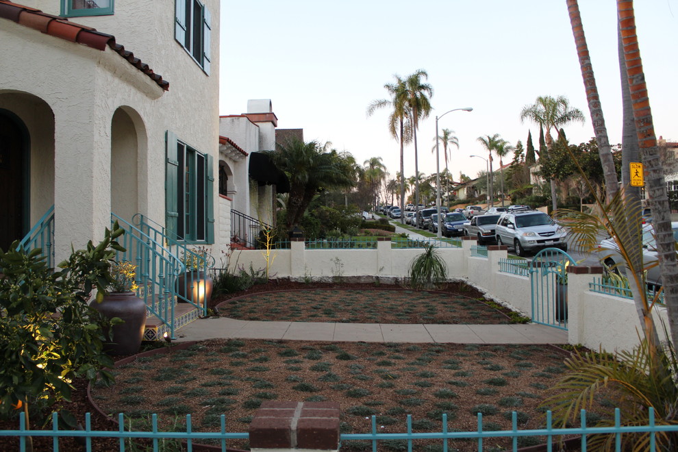 This is an example of a small mediterranean drought-tolerant and full sun front yard landscaping in Orange County.