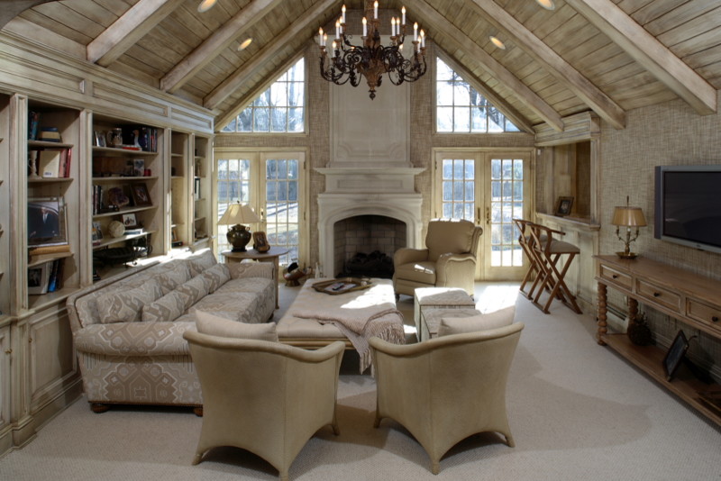 Design ideas for a large country formal open concept living room in New York with carpet, a standard fireplace, a wall-mounted tv, beige walls and a stone fireplace surround.