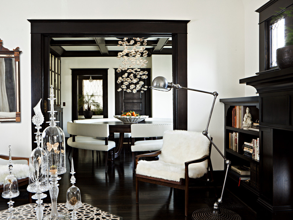 Traditional living room in Portland with white walls and black floor.