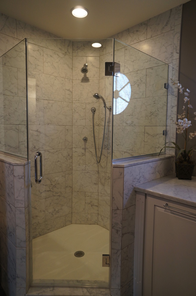 Inspiration for a mid-sized traditional master bathroom in Philadelphia with an undermount sink, furniture-like cabinets, dark wood cabinets, marble benchtops, a corner shower, a two-piece toilet, white tile, ceramic tile, beige walls and porcelain floors.