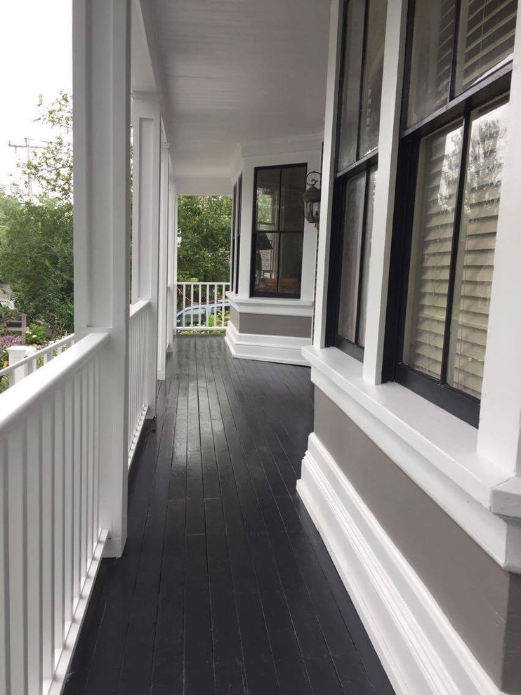 Photo of a large traditional front yard verandah in Boston with decking and a roof extension.
