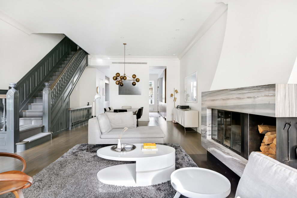 Идея дизайна: парадная, открытая гостиная комната в современном стиле с белыми стенами, паркетным полом среднего тона, стандартным камином, фасадом камина из камня и коричневым полом без телевизора