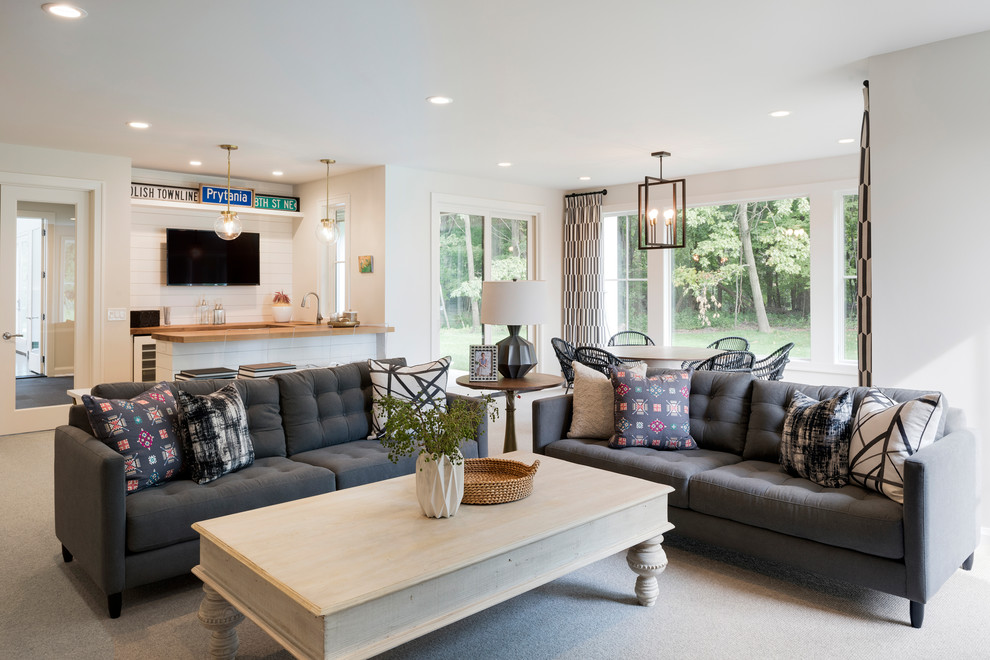 Mid-sized transitional open concept family room in Minneapolis with a home bar, white walls, carpet, a wall-mounted tv, grey floor and no fireplace.