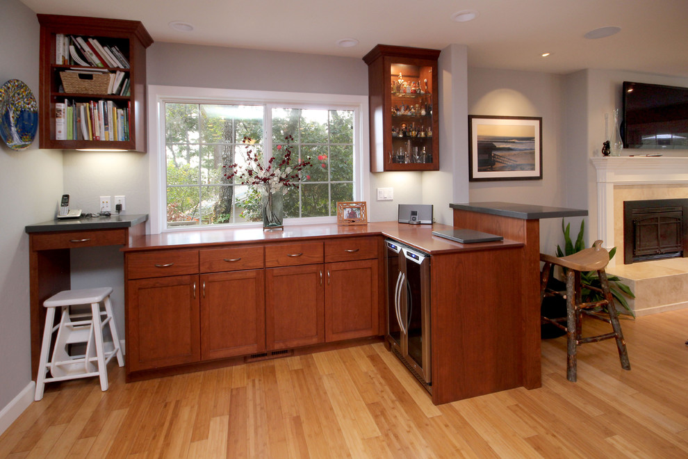 Large modern galley home bar in San Francisco with an undermount sink, shaker cabinets, medium wood cabinets, quartz benchtops and bamboo floors.