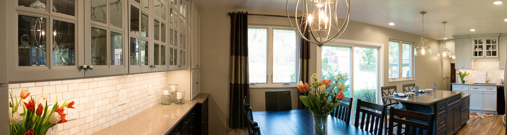 Eat-in kitchen - mid-sized transitional l-shaped vinyl floor eat-in kitchen idea with an undermount sink, recessed-panel cabinets, gray cabinets, quartz countertops, white backsplash, marble backsplash, stainless steel appliances and an island