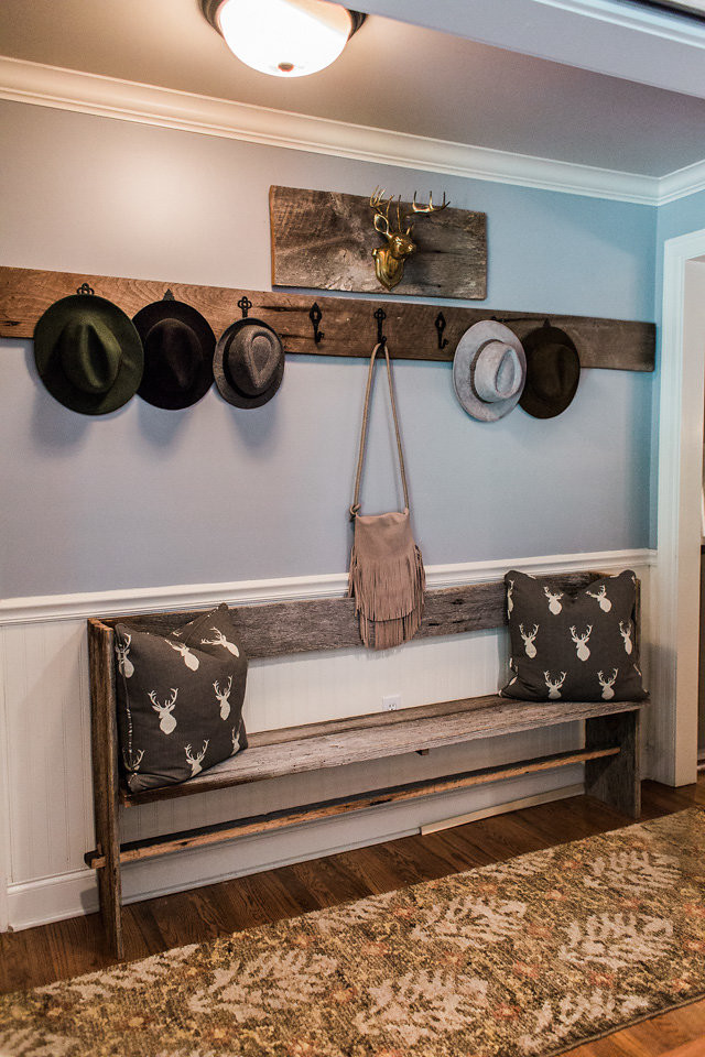 Example of a transitional medium tone wood floor and brown floor hallway design with blue walls