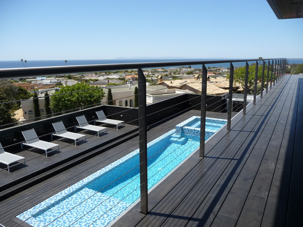 This is an example of a contemporary rooftop rectangular pool in Orange County with a hot tub.