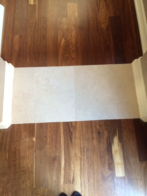 Example of a small transitional medium tone wood floor hallway design in Orange County with beige walls