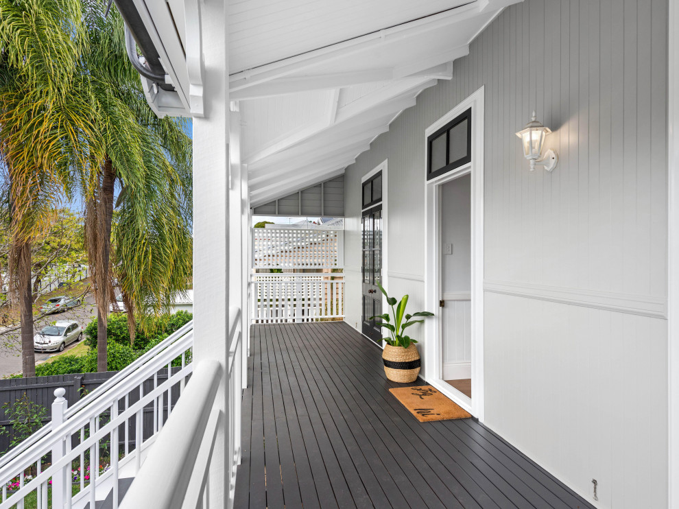 Design ideas for a mid-sized beach style two-storey grey house exterior in Brisbane with wood siding, a hip roof, a metal roof and a white roof.
