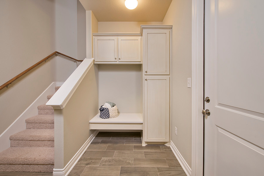 Photo of a mid-sized transitional hallway in Houston with grey walls, vinyl floors and brown floor.