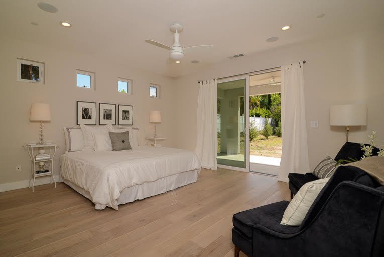 Design ideas for a large transitional master bedroom in Sacramento with beige walls, light hardwood floors and beige floor.