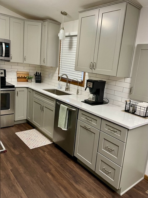 Example of a small transitional u-shaped enclosed kitchen design with shaker cabinets, gray cabinets and quartz countertops