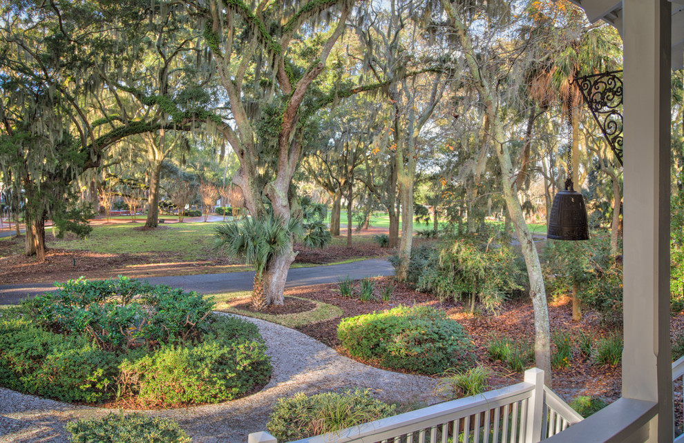 Photo of an expansive arts and crafts front yard partial sun driveway in Charleston with a garden path and gravel.