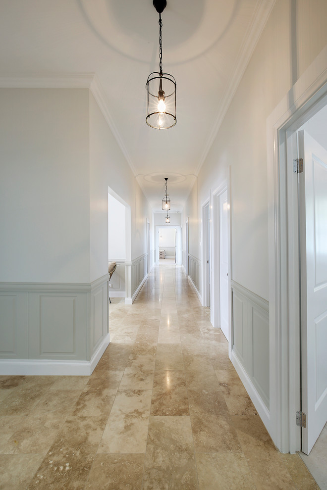 Inspiration for an expansive traditional hallway in Sydney with beige walls and travertine floors.