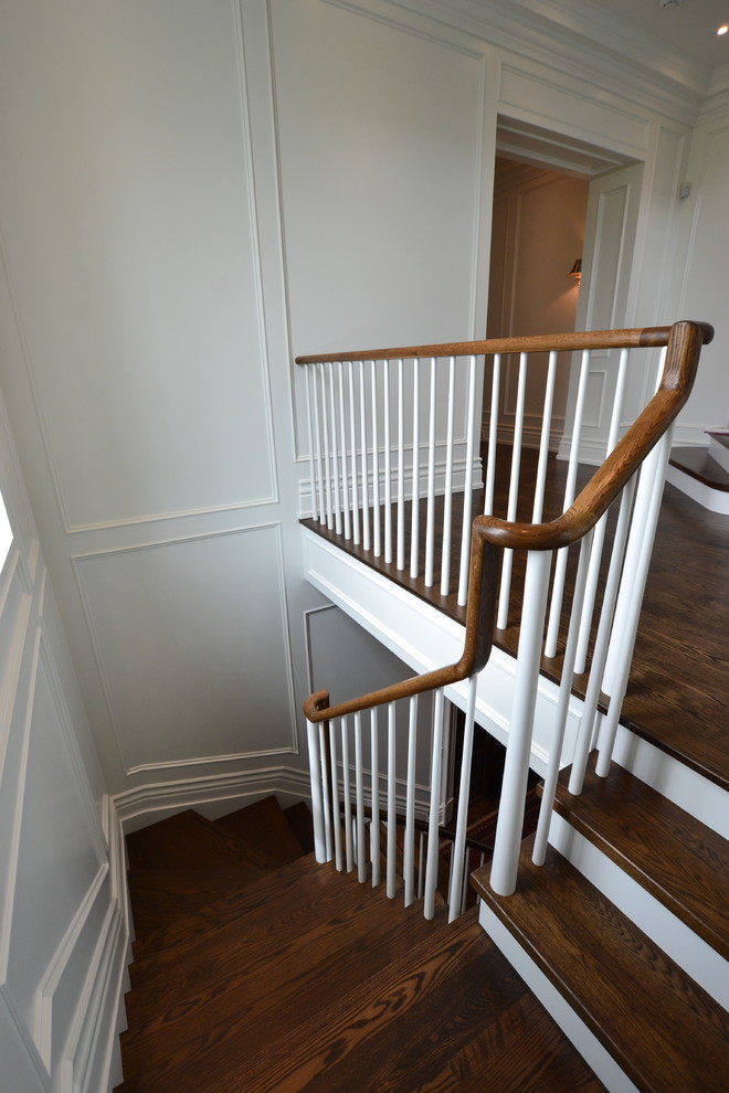 Photo of a traditional wood l-shaped staircase in Toronto with painted wood risers and wood railing.