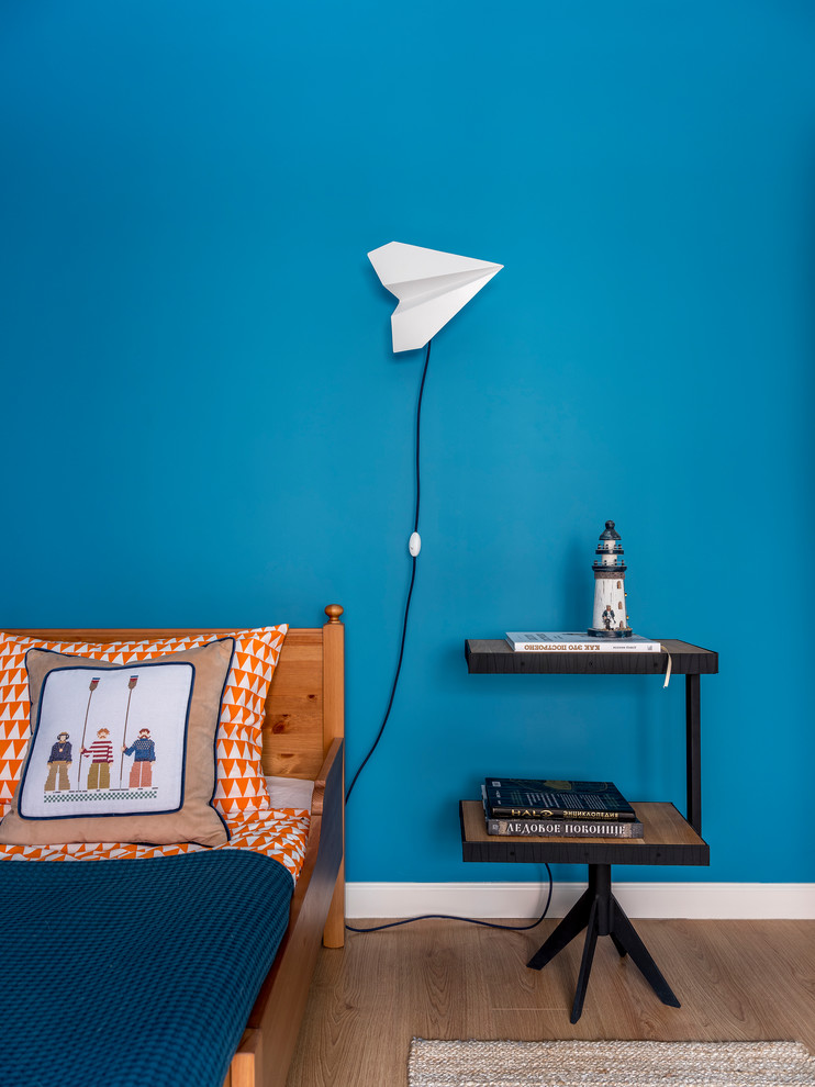 Photo of a mid-sized beach style kids' room for boys in Moscow with blue walls and light hardwood floors.