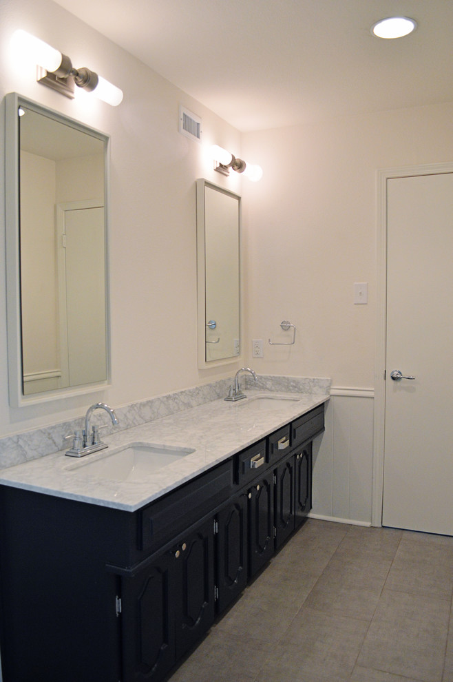 This is an example of a mid-sized transitional kids bathroom in Dallas with raised-panel cabinets, blue cabinets, an alcove tub, a shower/bathtub combo, white tile, subway tile, white walls, porcelain floors, an undermount sink, marble benchtops, grey floor and a shower curtain.