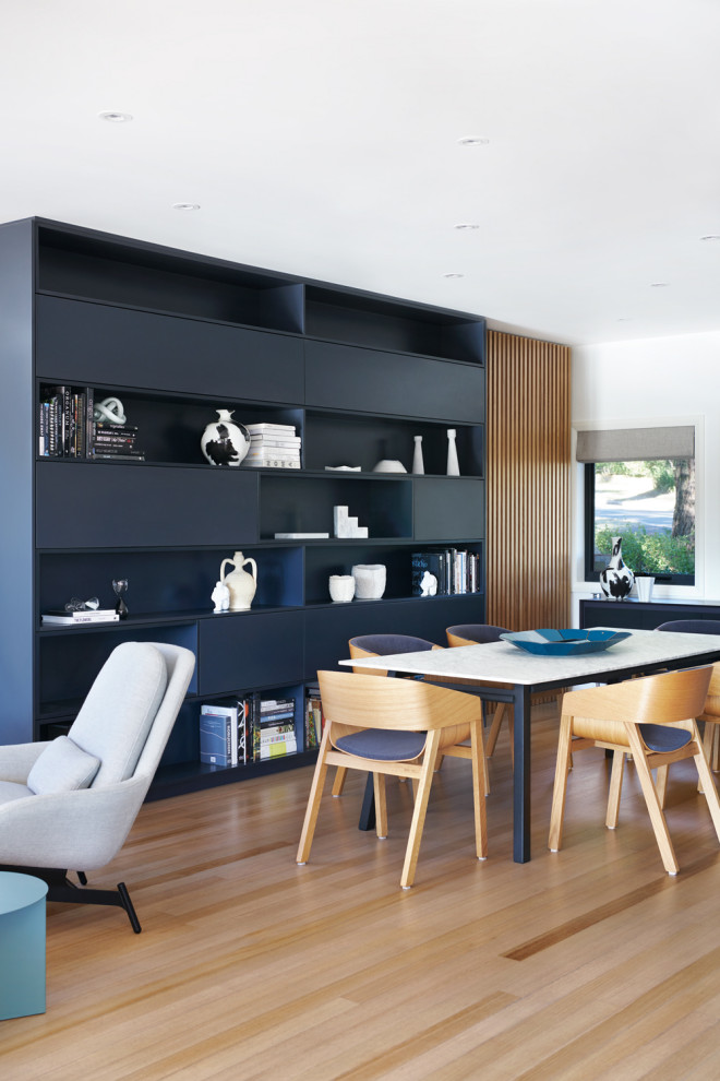 Photo of a large contemporary open plan dining in Sydney with white walls, medium hardwood floors, no fireplace and brown floor.
