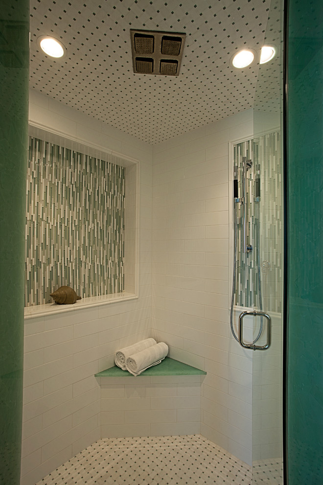 Inspiration for a large tropical master bathroom in Miami with beaded inset cabinets, brown cabinets, a freestanding tub, a corner shower, a two-piece toilet, blue tile, subway tile, blue walls, porcelain floors, a vessel sink, glass benchtops, beige floor and a hinged shower door.