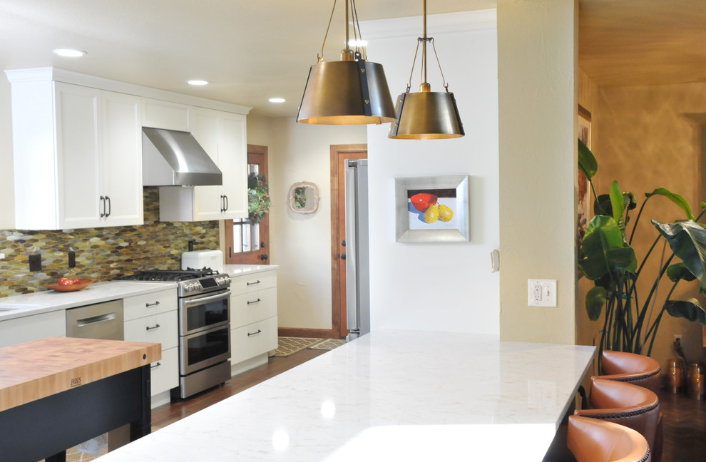 Open concept kitchen - large transitional galley ceramic tile and brown floor open concept kitchen idea in Oklahoma City with a single-bowl sink, shaker cabinets, white cabinets, quartz countertops, multicolored backsplash, glass tile backsplash, stainless steel appliances, an island and white countertops