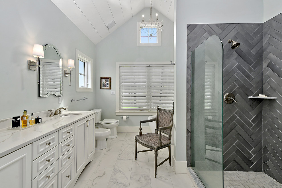 Photo of a large country master bathroom in Other with recessed-panel cabinets, white cabinets, gray tile, grey walls, an undermount sink, white floor, an open shower, white benchtops, a freestanding tub, a corner shower, an urinal, marble floors and quartzite benchtops.