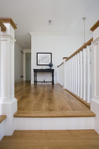 Inspiration for an expansive traditional hallway in Chicago with white walls and light hardwood floors.