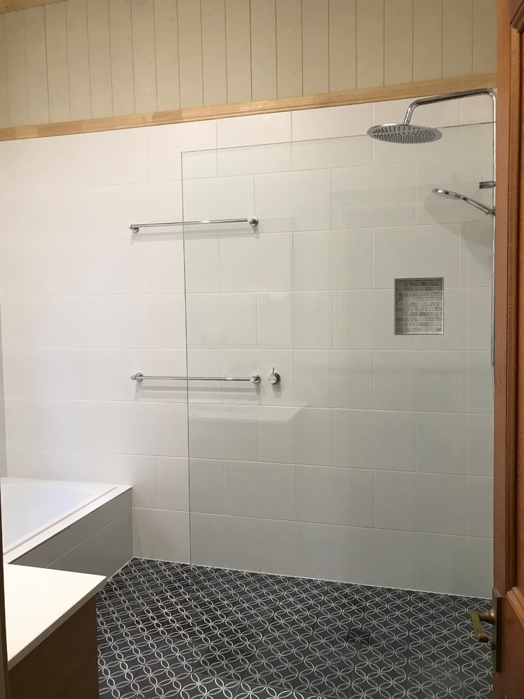Inspiration for a small contemporary 3/4 bathroom in Brisbane with flat-panel cabinets, dark wood cabinets, a curbless shower, a one-piece toilet, white tile, ceramic tile, white walls, cement tiles, an integrated sink, solid surface benchtops, blue floor, a hinged shower door and white benchtops.