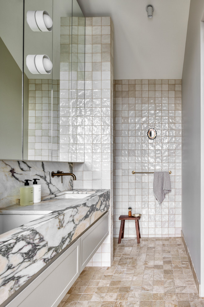 Photo of a transitional bathroom in Melbourne with shaker cabinets, white cabinets, a curbless shower, beige tile, white walls, an undermount sink, beige floor, an open shower, a double vanity and a floating vanity.