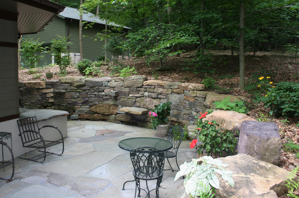 Photo of a mid-sized traditional backyard patio in Philadelphia with natural stone pavers and no cover.