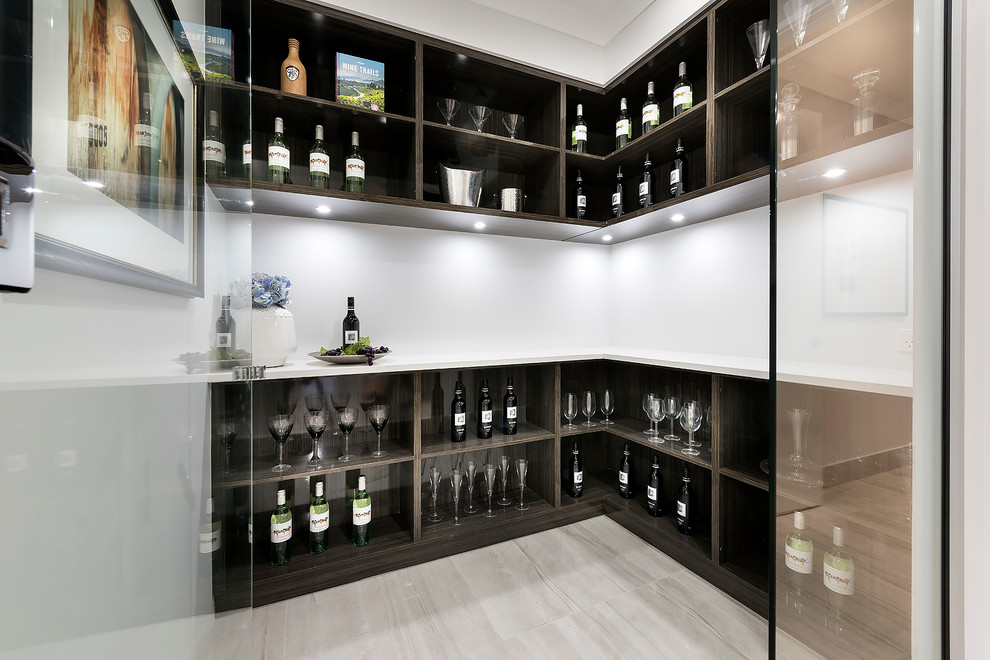 This is an example of a mid-sized contemporary wine cellar in Perth with porcelain floors and display racks.