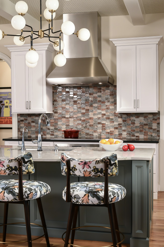 This is an example of a large transitional u-shaped separate kitchen in St Louis with an undermount sink, recessed-panel cabinets, white cabinets, quartzite benchtops, multi-coloured splashback, mosaic tile splashback, stainless steel appliances, light hardwood floors, with island, black benchtop and exposed beam.