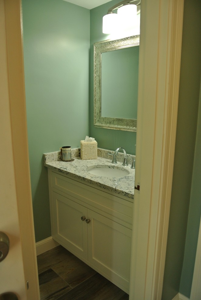 Example of a transitional light wood floor eat-in kitchen design in Boston with an undermount sink, shaker cabinets, granite countertops, white backsplash, subway tile backsplash, stainless steel appliances and an island