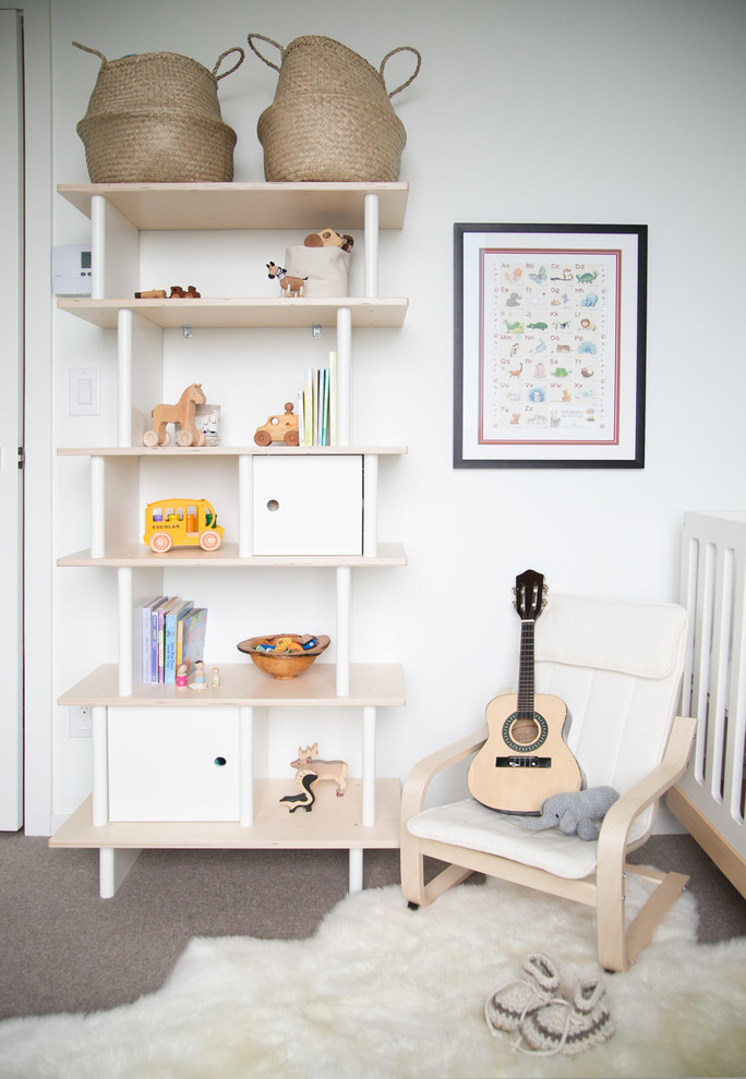 Design ideas for a scandinavian toddler room in Vancouver with white walls.