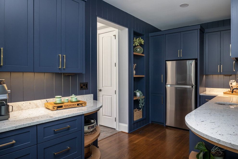 Inspiration for a large asian u-shaped kitchen pantry in Raleigh with an undermount sink, shaker cabinets, blue cabinets, granite benchtops, white splashback, granite splashback, stainless steel appliances, medium hardwood floors, no island, brown floor and white benchtop.