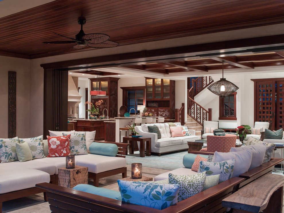 Inspiration for a large tropical open concept living room in Hawaii with white walls, no fireplace and beige floor.