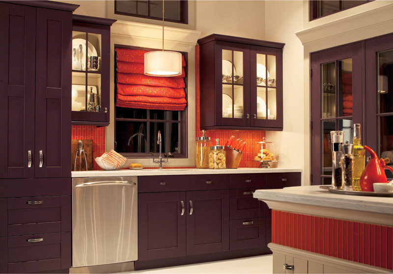 Photo of a large traditional l-shaped eat-in kitchen in New York with a drop-in sink, shaker cabinets, purple cabinets, solid surface benchtops, orange splashback, mosaic tile splashback, stainless steel appliances, ceramic floors, with island and beige floor.