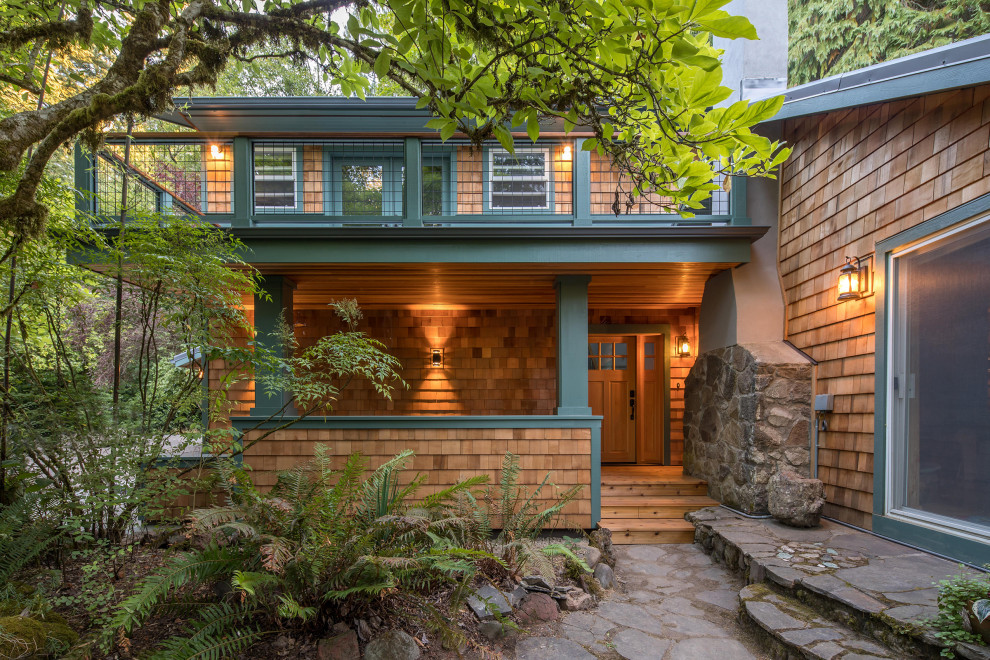Inspiration for a large contemporary two-story wood and shingle exterior home remodel in Portland with a metal roof