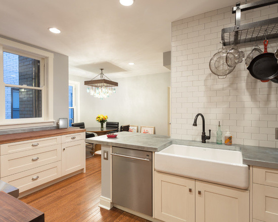 This is an example of a mid-sized transitional galley eat-in kitchen in Chicago with a farmhouse sink, shaker cabinets, white cabinets, wood benchtops, multi-coloured splashback, terra-cotta splashback, stainless steel appliances, medium hardwood floors and no island.