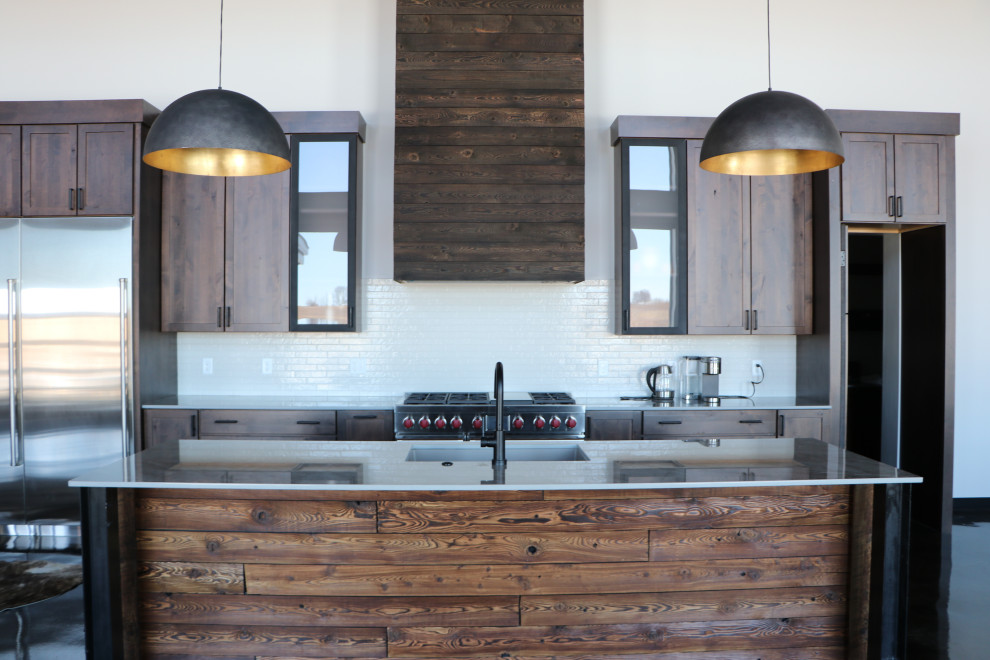 Open concept kitchen - mid-sized rustic galley brown floor and vaulted ceiling open concept kitchen idea with an undermount sink, shaker cabinets, dark wood cabinets, quartz countertops, white backsplash, ceramic backsplash, stainless steel appliances, an island and white countertops