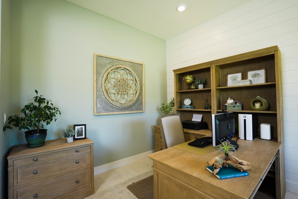 Photo of a transitional home office in Sacramento with green walls, porcelain floors, a freestanding desk, beige floor and planked wall panelling.